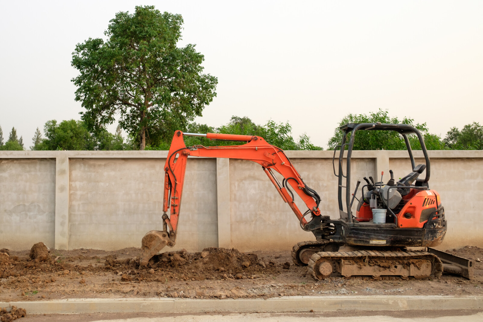 Small excavator working on a road project where a larger machine may now be needed